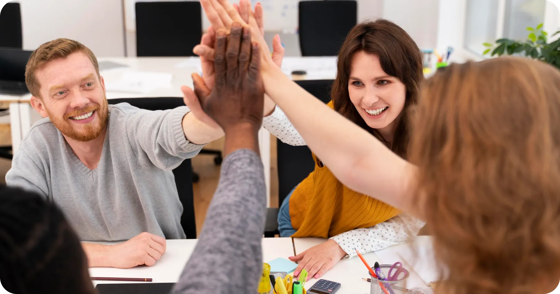 a group of people giving each other a high five