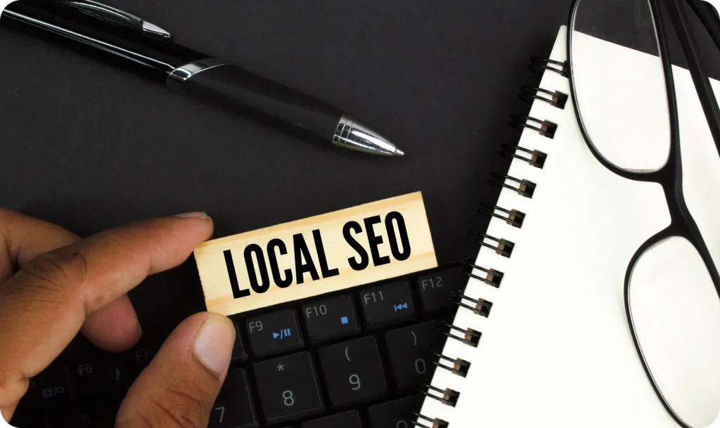 a hand holding a block with text on it next to a keyboard